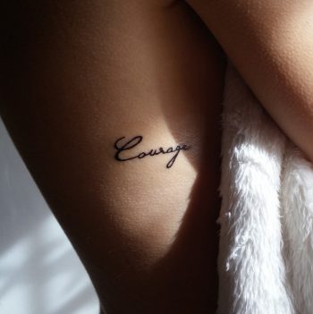 Courage tattoo on the rib