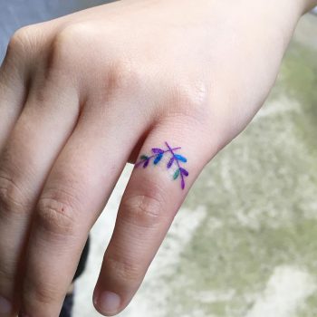 Crossed twig tattoo