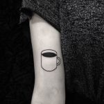 Cup of coffee tattoo on the arm