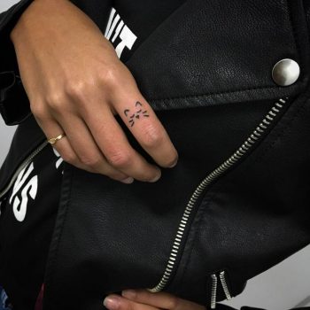 Cute tiny cat tattoo on the finger