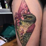 Dinosaur in a rhombus tattoo