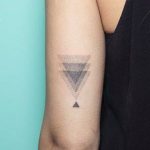 Disappearing gradient triangle tattoo