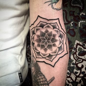 Dotwork black mandala on the inner forearm