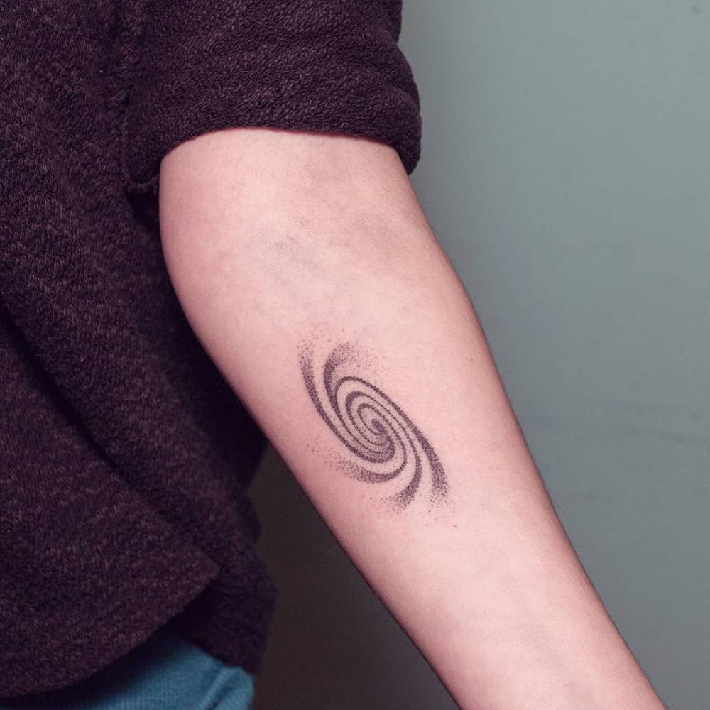 Dotwork spiral tattoo on the forearm