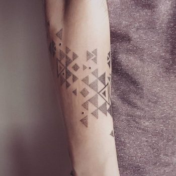 Dotwork triangles tattoo on the forearm