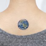 Earth globe tattoo on the back