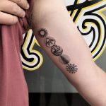 Five elements tattoo on the upper arm