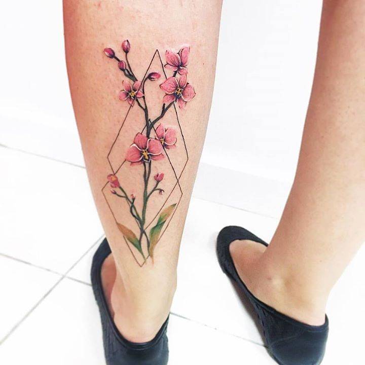 Flower and rhombus tattoo on the calf