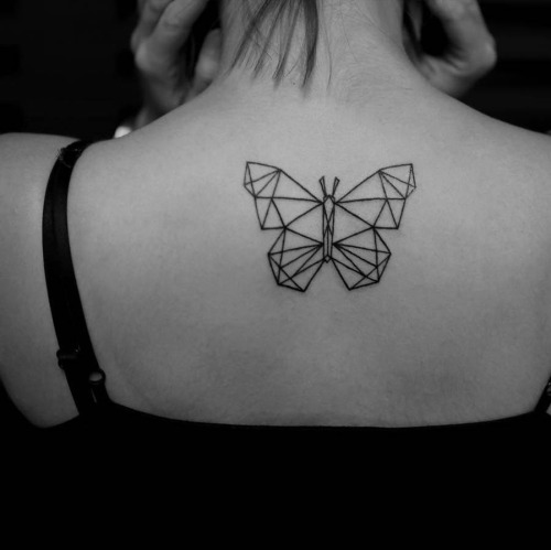 Geometric butterfly tattoo on the upper back