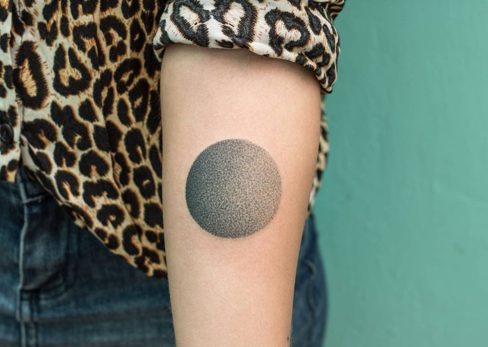 Gradient black circle tattoo