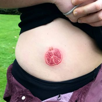 Half pomegranate tattoo