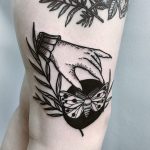 Hand and butterfly tattoo
