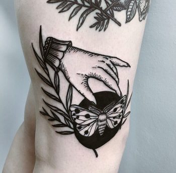 Hand and butterfly tattoo