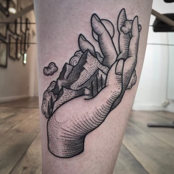 Hand and mountains tattoo