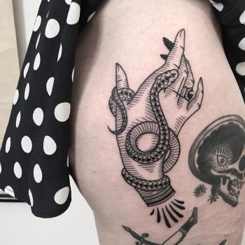 Hand with a snake tattoo