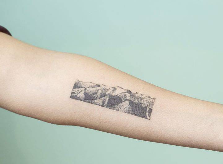 Handpoked rectangular mountains landscape tattoo