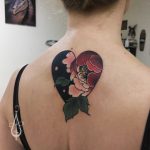 Heart shaped flower tattoo on the upper back