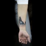 Howling wolf tattoo on the inner wrist