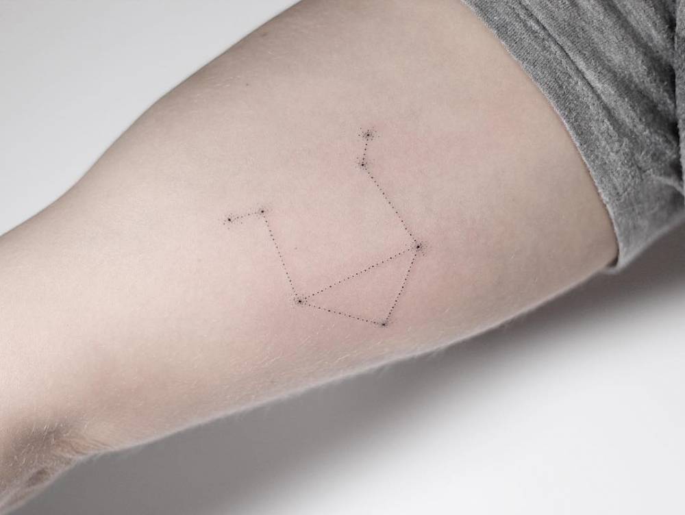 Libra constellation tattoo on the bicep