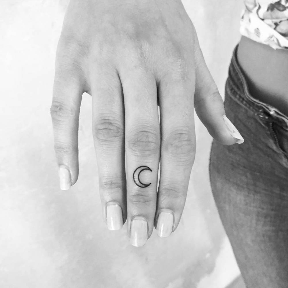 Little crescent moon tattoo on the middle finger