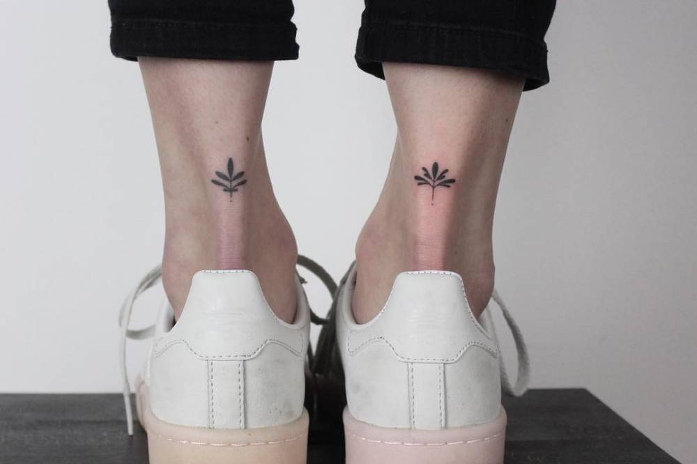 Lotus flower tattoos on the ankles