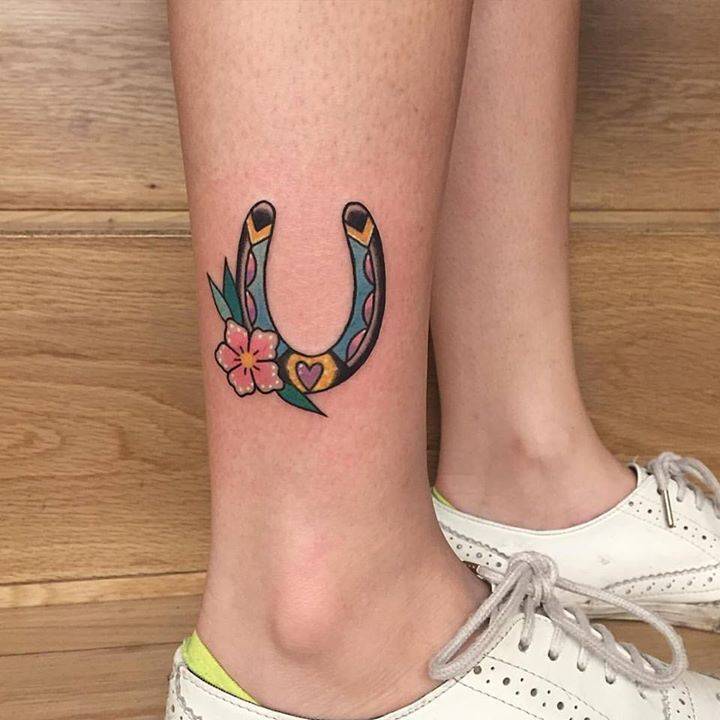Lucky horseshoe and flower tattoo