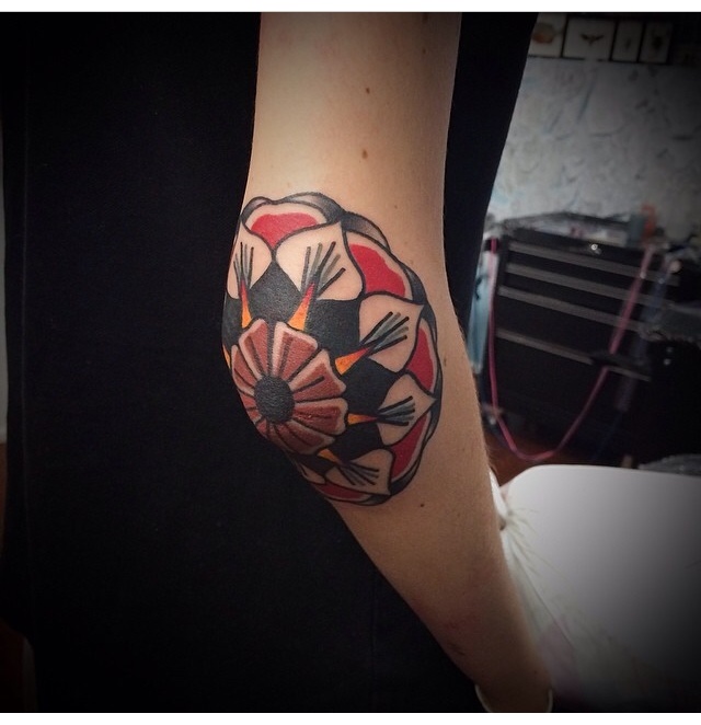 Mandala tattoo on the right elbow