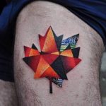 Maple leaf tattoo on the thigh