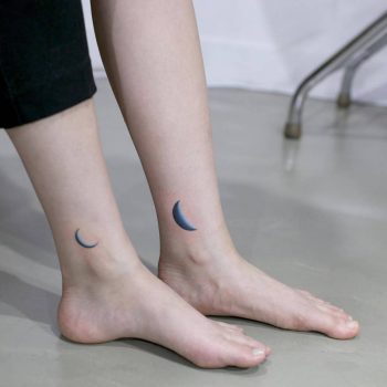 Matching crescent moon tattoos on ankles