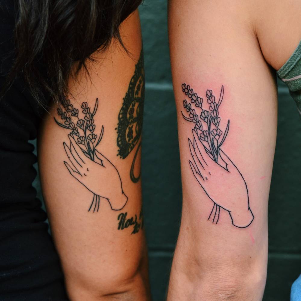 Matching hand with flowers tattoos