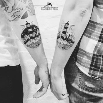 Matching lighthouse tattoos