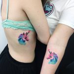 Matching watercolor unicorn tattoos