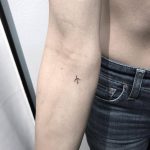 Micro airplane tattoo on the forearm