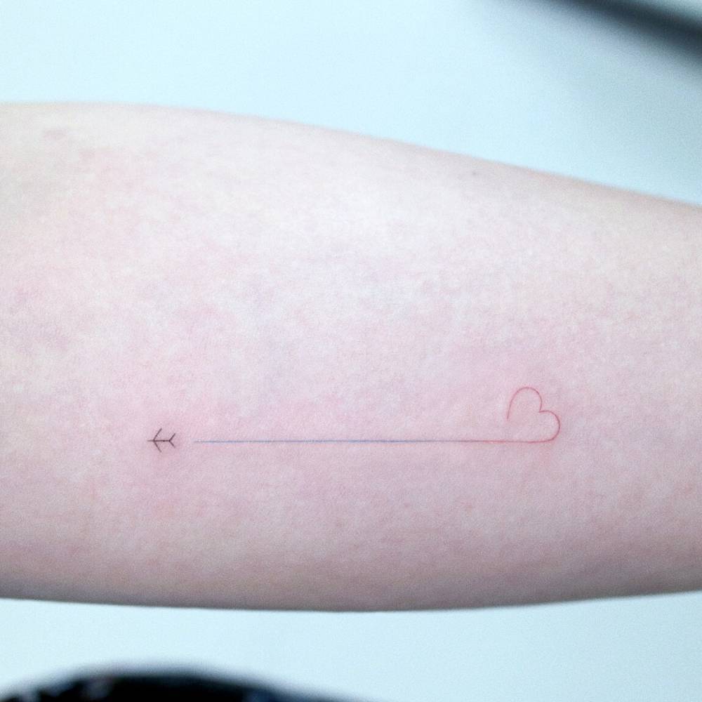 Micro plane and heart tattoo