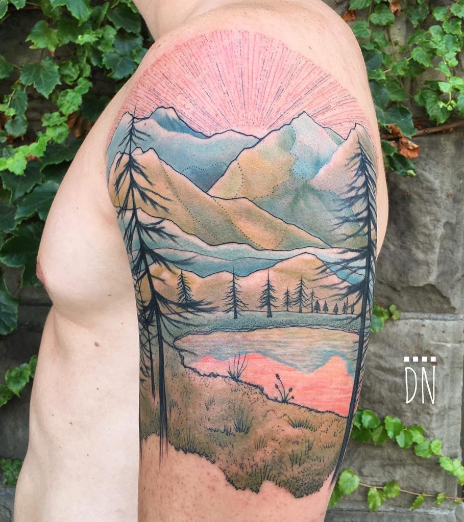Mountainous landscape tattoo on the left arm