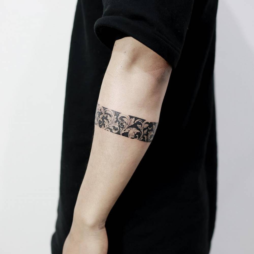 Negative space black and whie armband tattoo