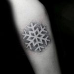 Negative space dotwork snowflake tattoo