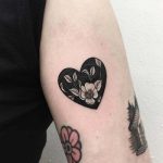 Negative space heart shaped flower tattoo