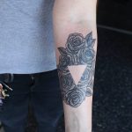 Negative space roses and triangle tattoo
