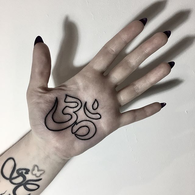 Om symbol tattoo on the palm