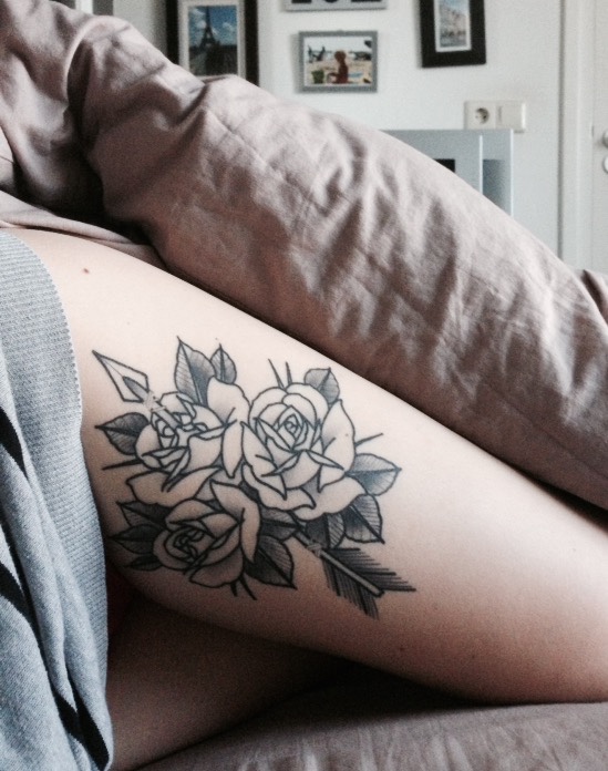 Outline black roses tattoo on the left thigh
