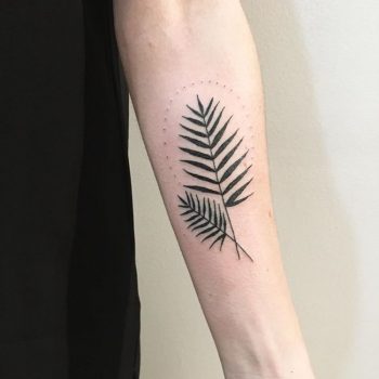 Palm leaf tattoo on the left inner arm