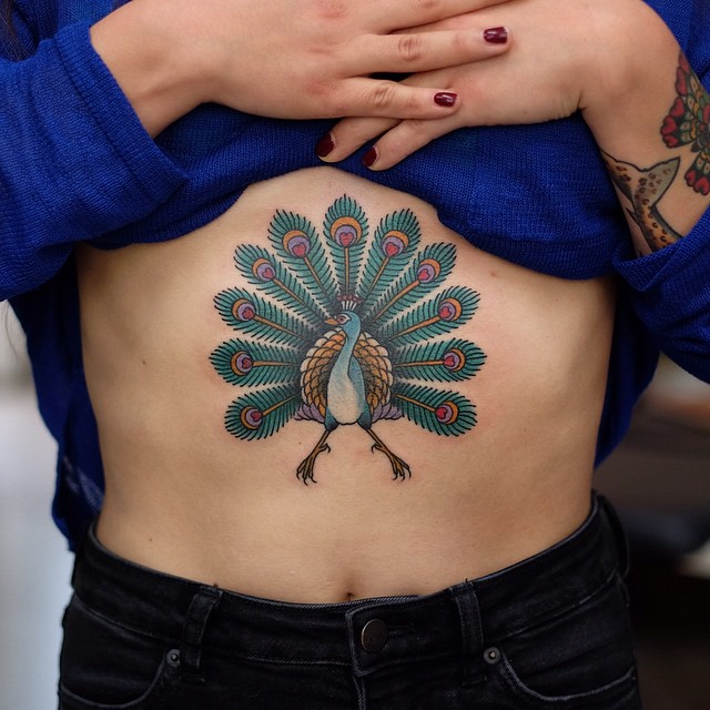 Peacock tattoo on the sternum