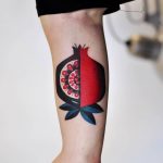 Pomegranate tattoo on the bicep