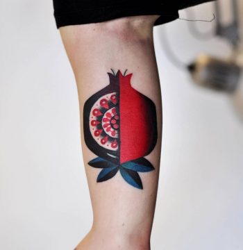Pomegranate tattoo on the bicep