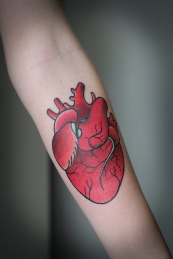 Red heart tattoo on the forearm
