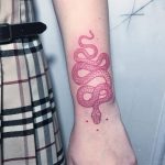 Red snake tattoo on the left outer forearm