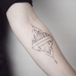 Rhombus shaped city and mountain tattoo