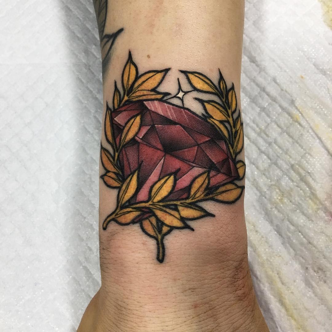 Ruby and golden branches tattoo