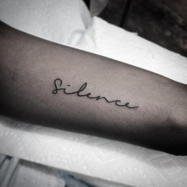 Silence tattoo on the arm